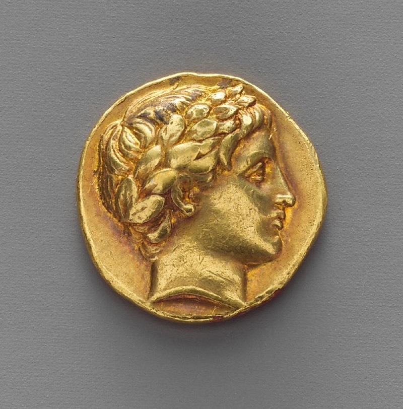 Ancient gold stater coin struck with a laurelled head